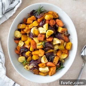 Roasted root vegetables in a white serving bowl