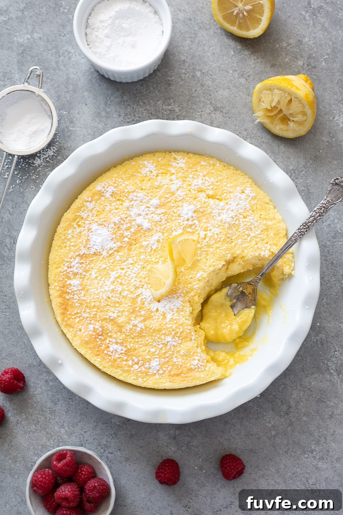 Spoon digging into lemon pudding cake