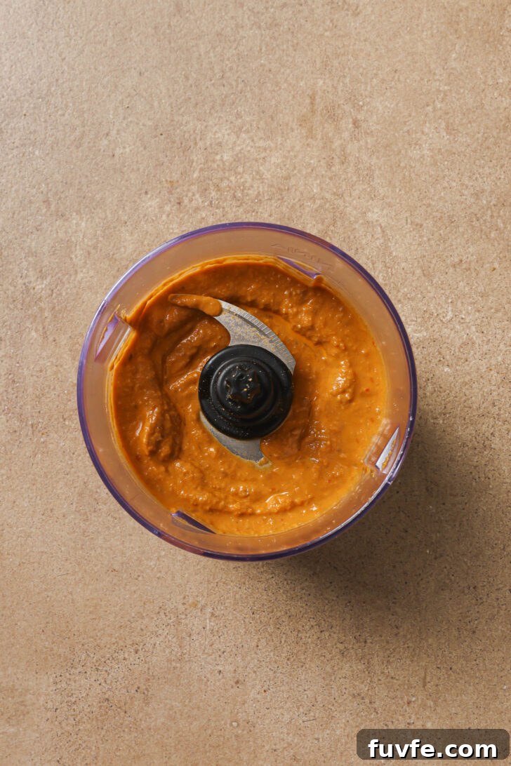 Ground spice powders, nut/seed mixture, tomato sauce, and water blended into a paste.