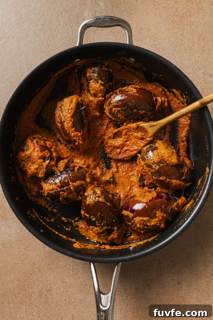 Bagare Baingan in a skillet ready to be simmered.