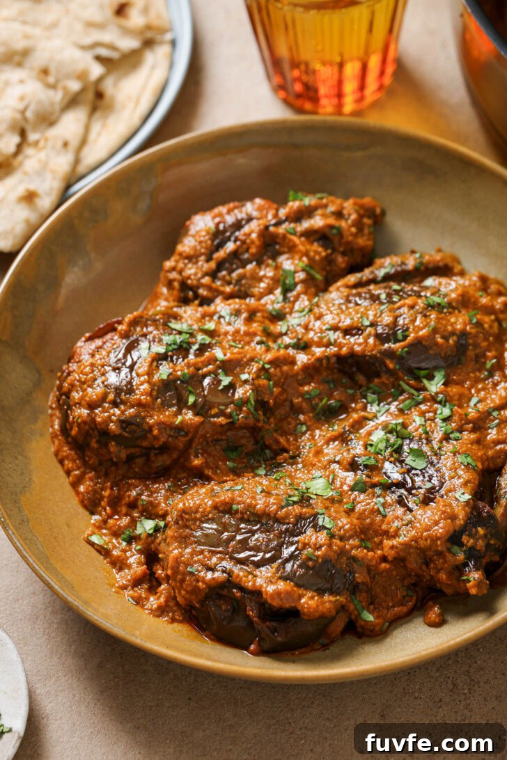Bagare Baingan in a plate garnished with minced cilantro.