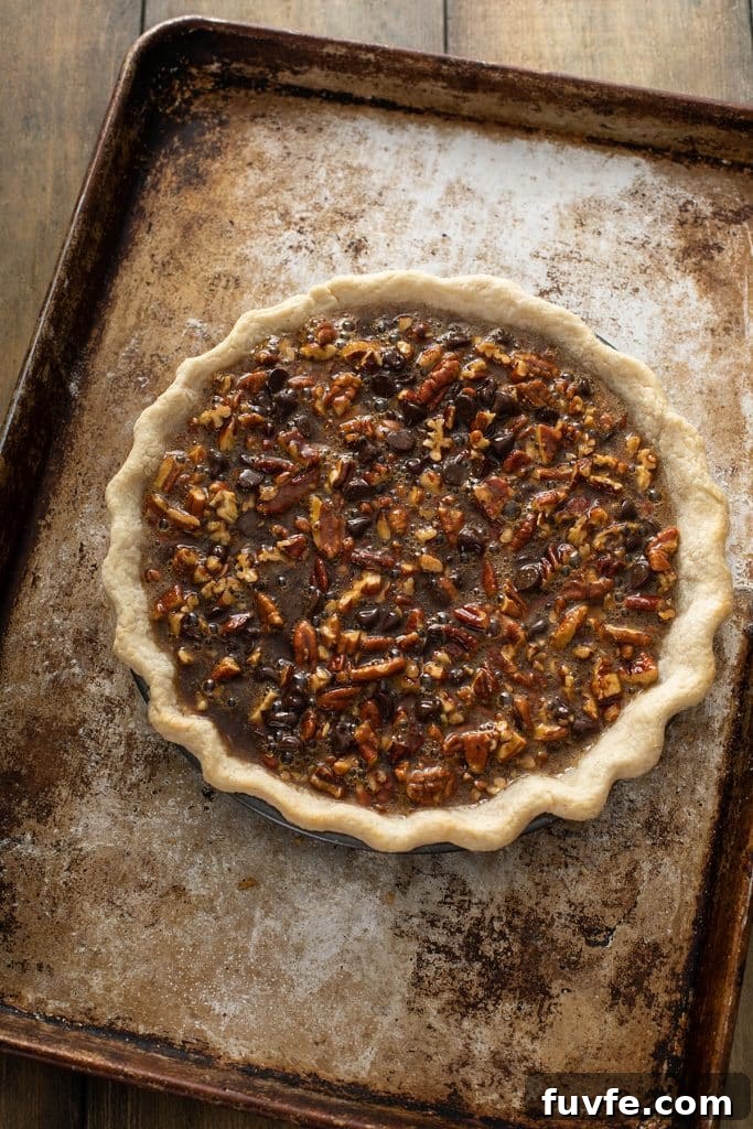 Chocolate Pecan pie on a baking dish ready to bake.