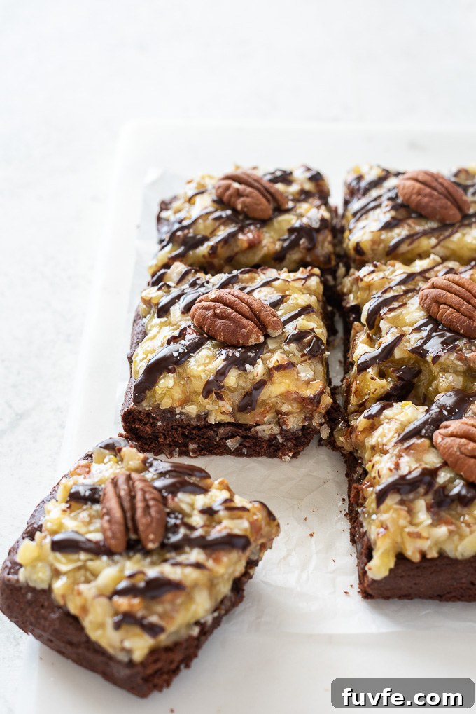 Fudgy German Chocolate Brownies with Coconut Pecan Frosting 5 German chocolate brownies cut into squares with pecan halves on top