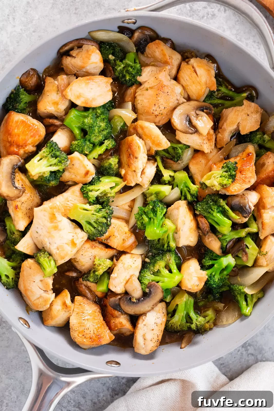 chicken and broccoli stir fry in a skillet