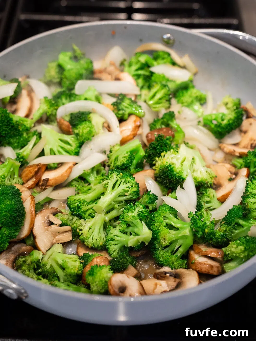 sauteing broccoli, mushrooms and onions in a skillet