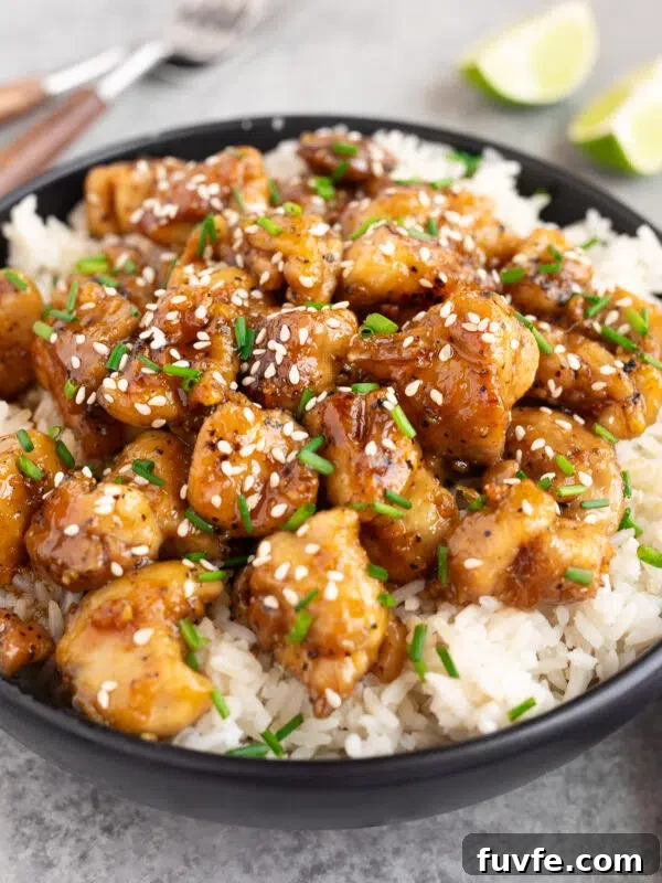 honey garlic chicken over white rice in a bowl