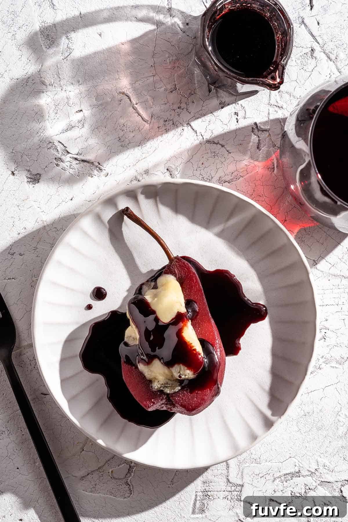 Poached Pear on Plate with wine on the side