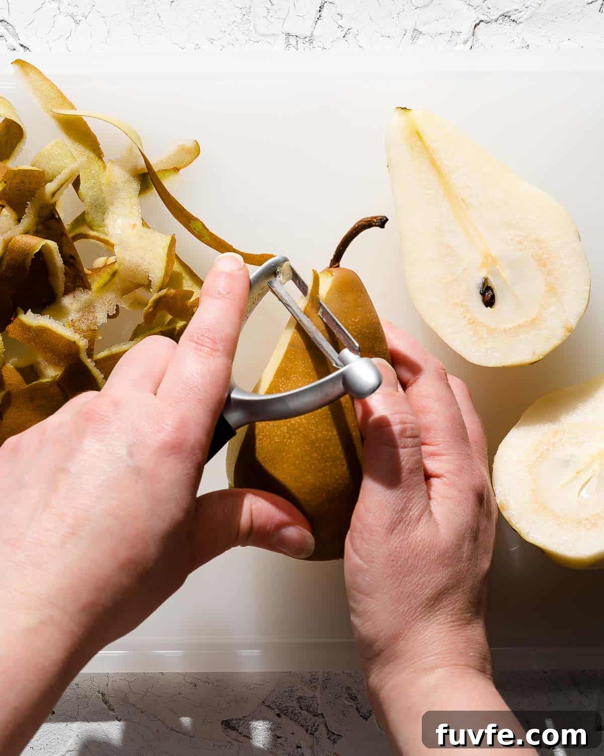peeling pear with vegetable peeler