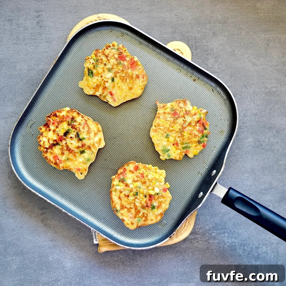 Corn Fritters Recipe with WW Points and Smart Serving Tips 5 Cooked corn fritters on a skillet