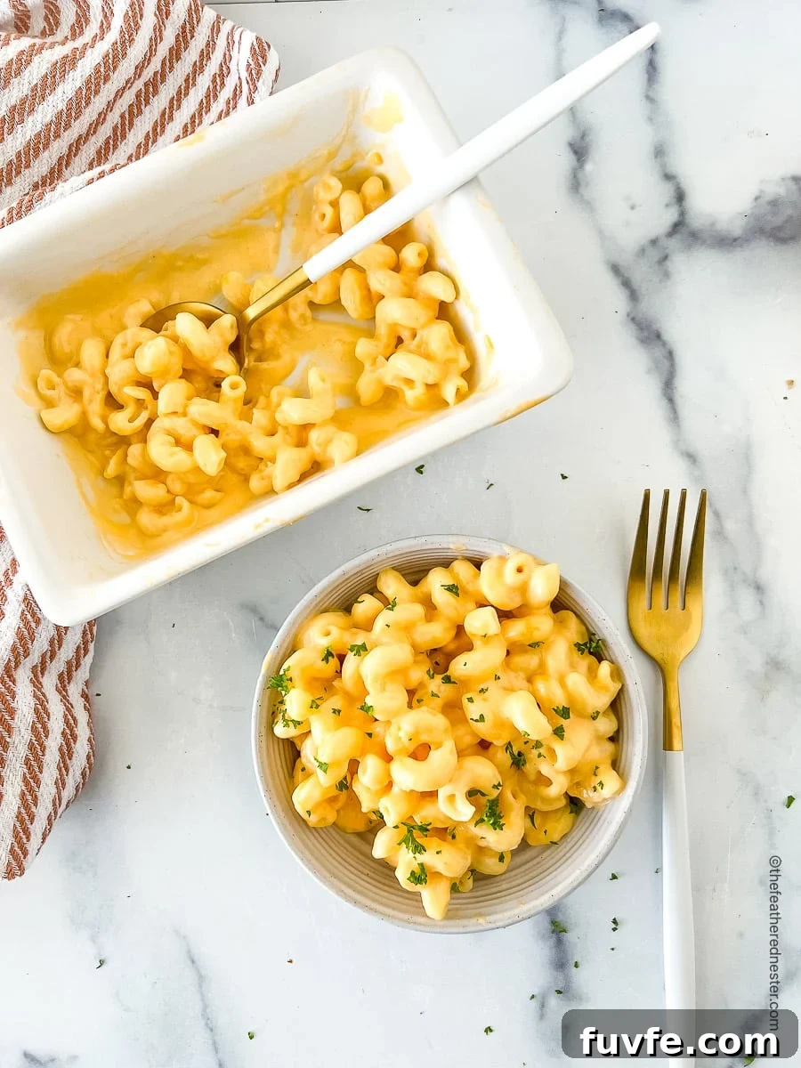 top view photo of macaroni with Velveeta cheese sauce in a bowl and another one in a serving platter.