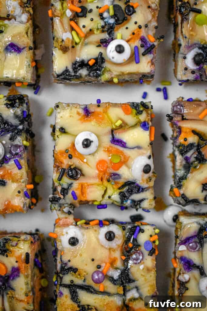 Nine Halloween Cheesecake Funfetti Bars are on a serving plate. This is a close up shot of them from above.