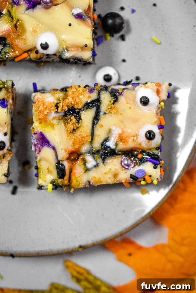 One Halloween cheesecake bar is on a plate
