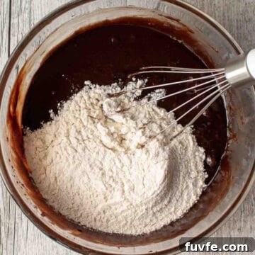 Flour added on top of melted chocolate mixture.