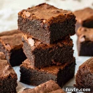 Three espresso brownies stacked with more brownies around.