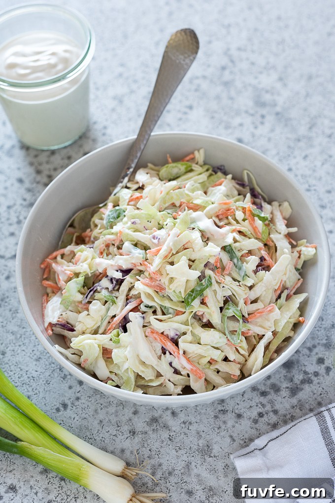 How to Make Classic Coleslaw 6 Coleslaw in a bowl with a spoon buried inside