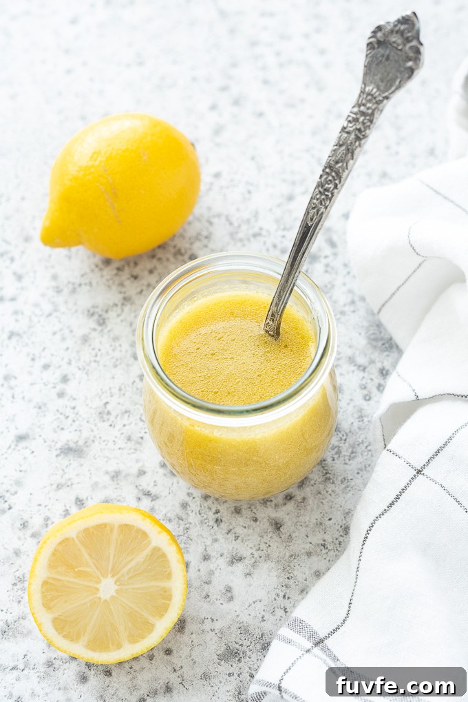 Spoon in a jar of lemon vinaigrette