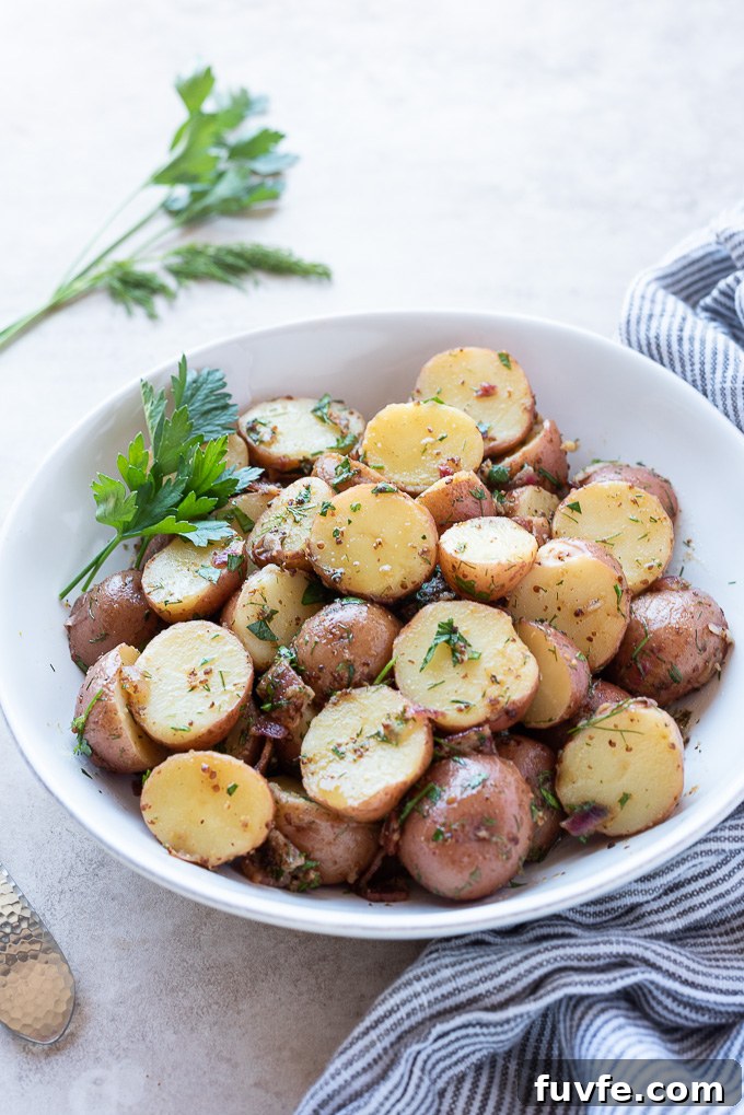 Authentic German Potato Salad Recipe 7 Warm German potato salad in a bowl with parsley and dill