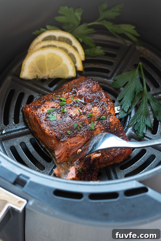 Salmon in the air fryer with a fork digging into it