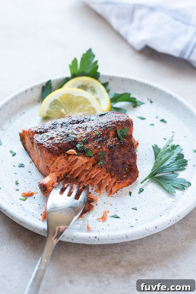 Fork cutting into air fryer salmon filet
