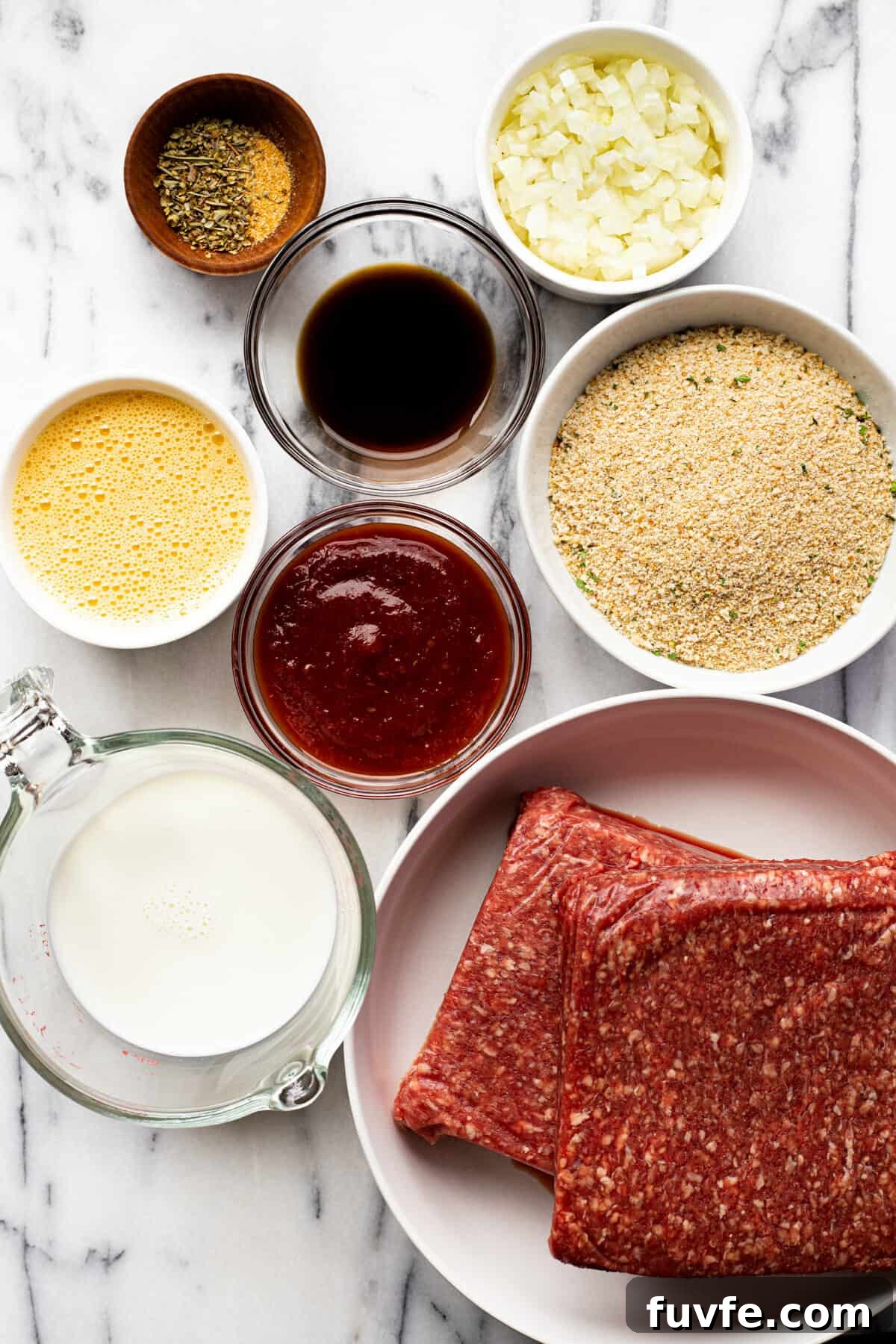 White marble counter top with bowls of ingredients to make homemade smoked meatloaf.