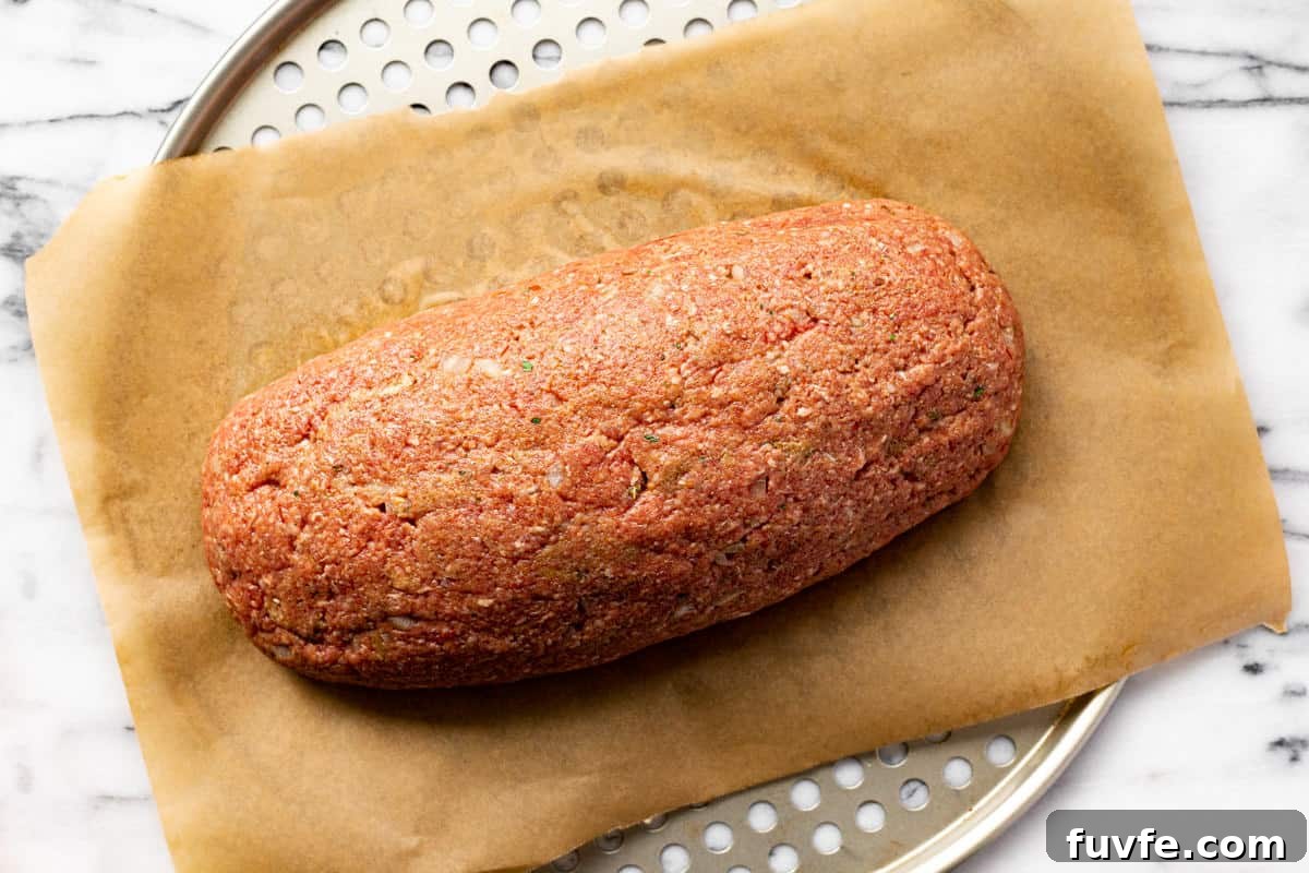Meatloaf on a parchment lined pizza pan.