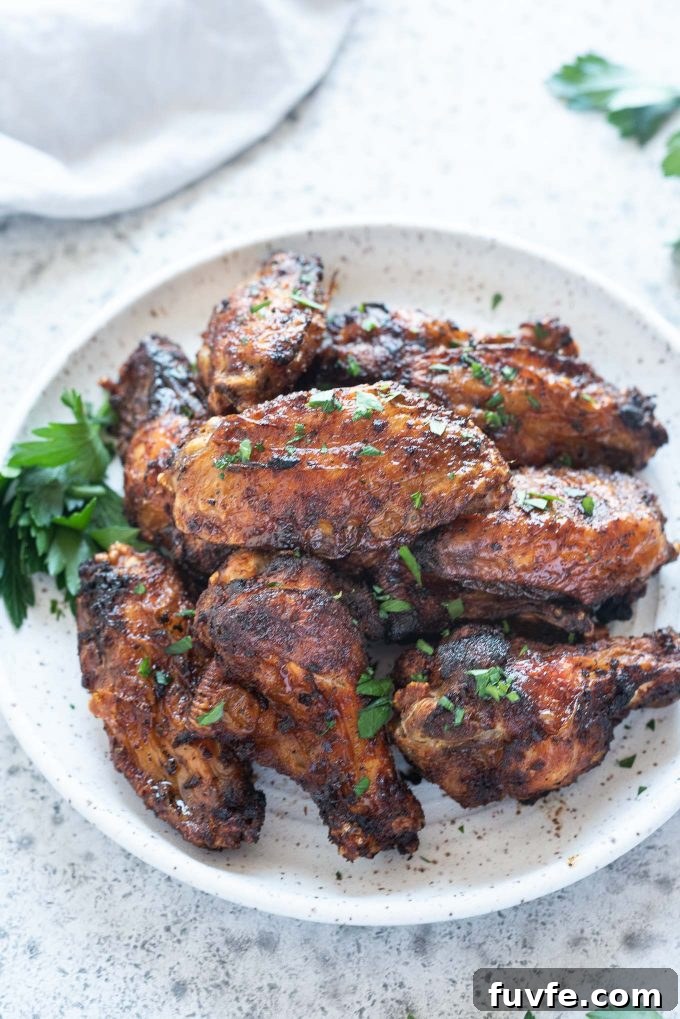 How to Make Crispy Air Fryer Chicken Wings 2 Air fryer chicken wings piled on a plate
