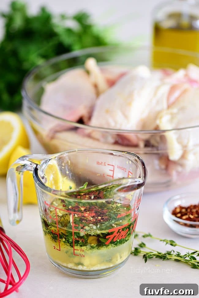 Zesty Lemon Herb Marinade for Grilled Chicken 4 lemon herb chicken marinade in measuring cup with raw chicken