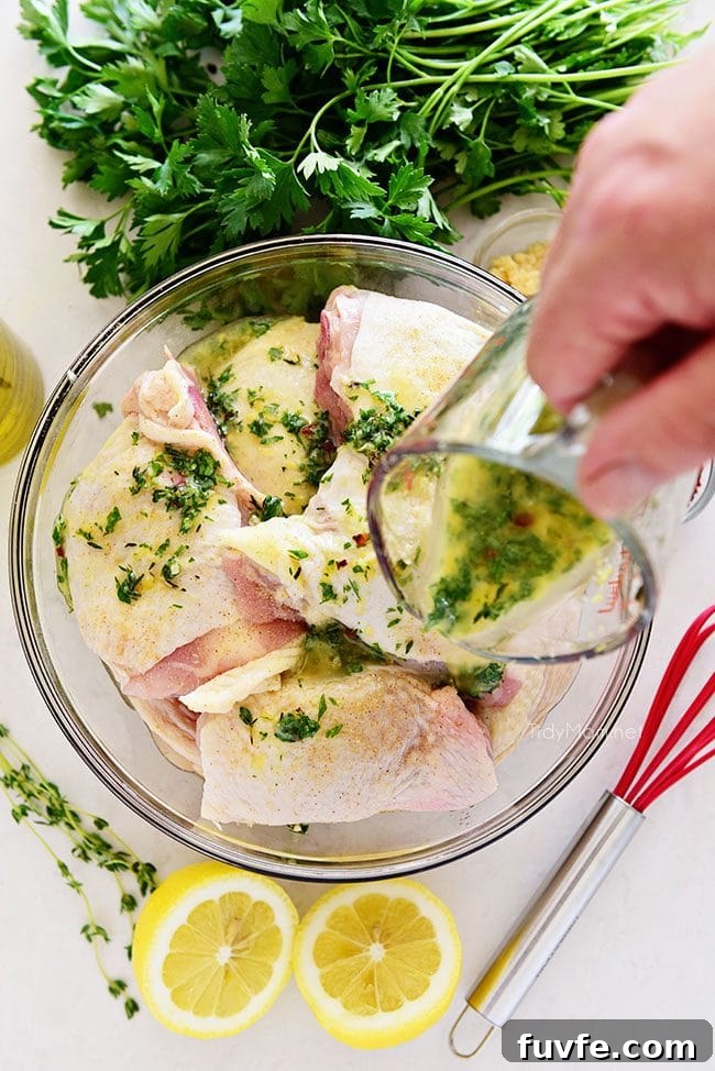 Zesty Lemon Herb Marinade for Grilled Chicken 5 pouring easy lemon herb chicken marinade over raw chicken