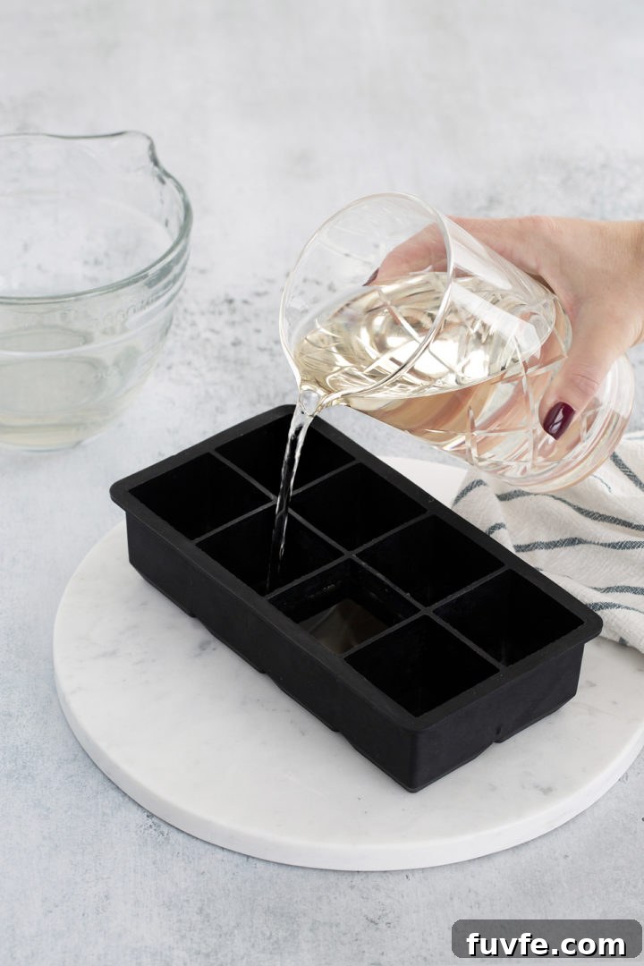 How to Make Smoked Ice at Home: Simple Steps for Cocktail Smoke Flavor 5 pouring smoked water into ice cube trays