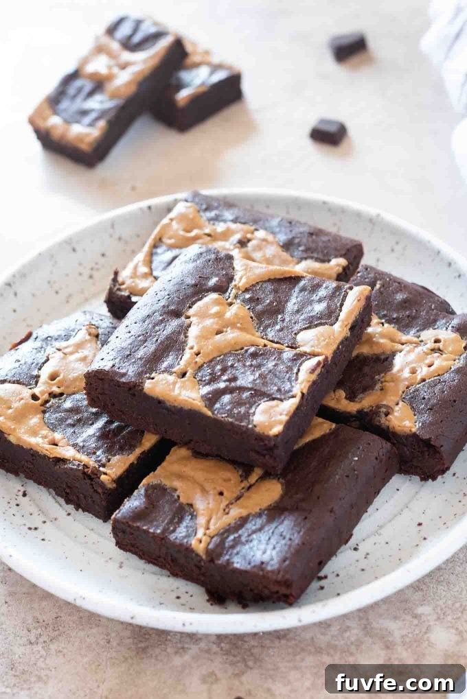 Fudgy Peanut Butter Brownies Recipe 2 Peanut butter brownies piled on a white plate