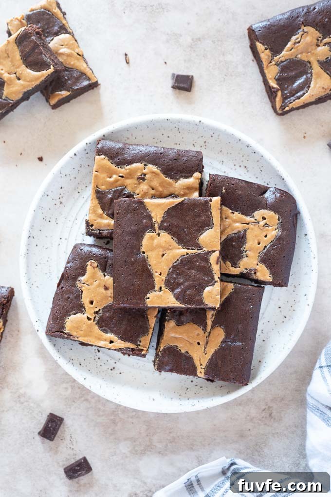 Fudgy Peanut Butter Brownies with Chocolate Swirl 8 Peanut butter swirl brownies on a white plate