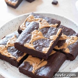 Fudgy Peanut Butter Brownies with Chocolate Swirl 9 Peanut butter brownies piled on a white plate