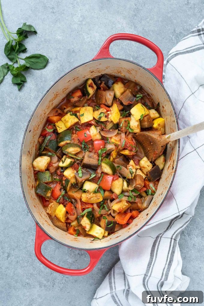 Ratatouille in a Dutch oven with basil on top