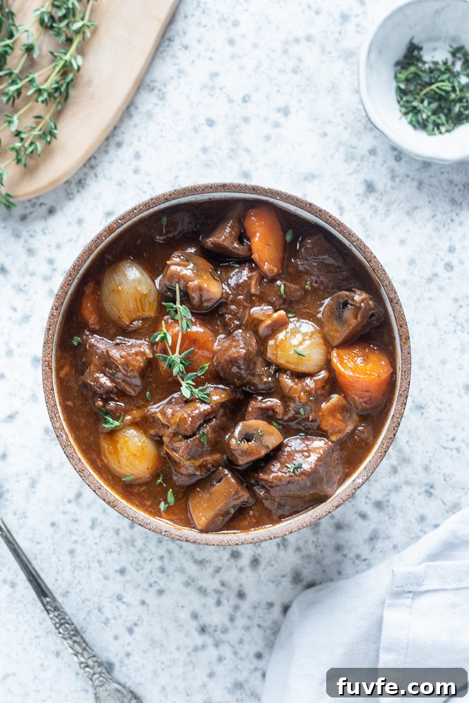 Instant Pot Beef Bourguignon Recipe 3 Bowl of beef bourguignon with sprig of thyme on top