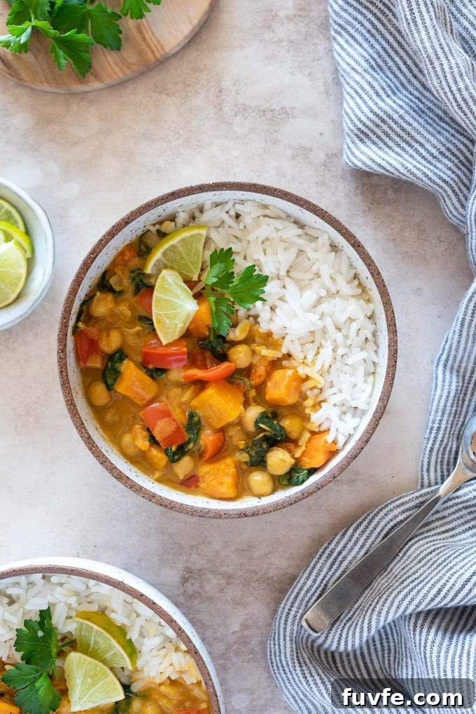 Instant Pot Sweet Potato and Chickpea Curry 2 Instant pot sweet potato chickpea curry in a bowl with lime and cilantro