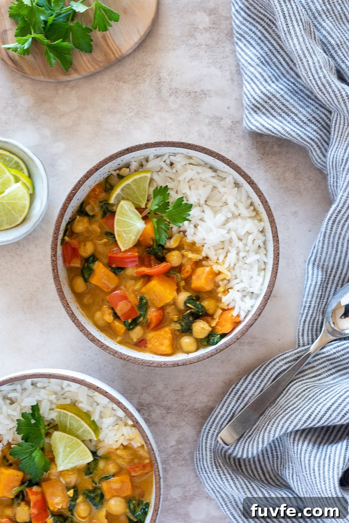 Creamy Vegan Instant Pot Sweet Potato Chickpea Curry 7 Bowl of chickpea curry with rice, limes and cilantro