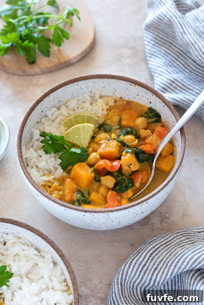 Instant Pot Sweet Potato and Chickpea Curry 8 Sweet potato chickpea curry in a bowl with spoon digging in