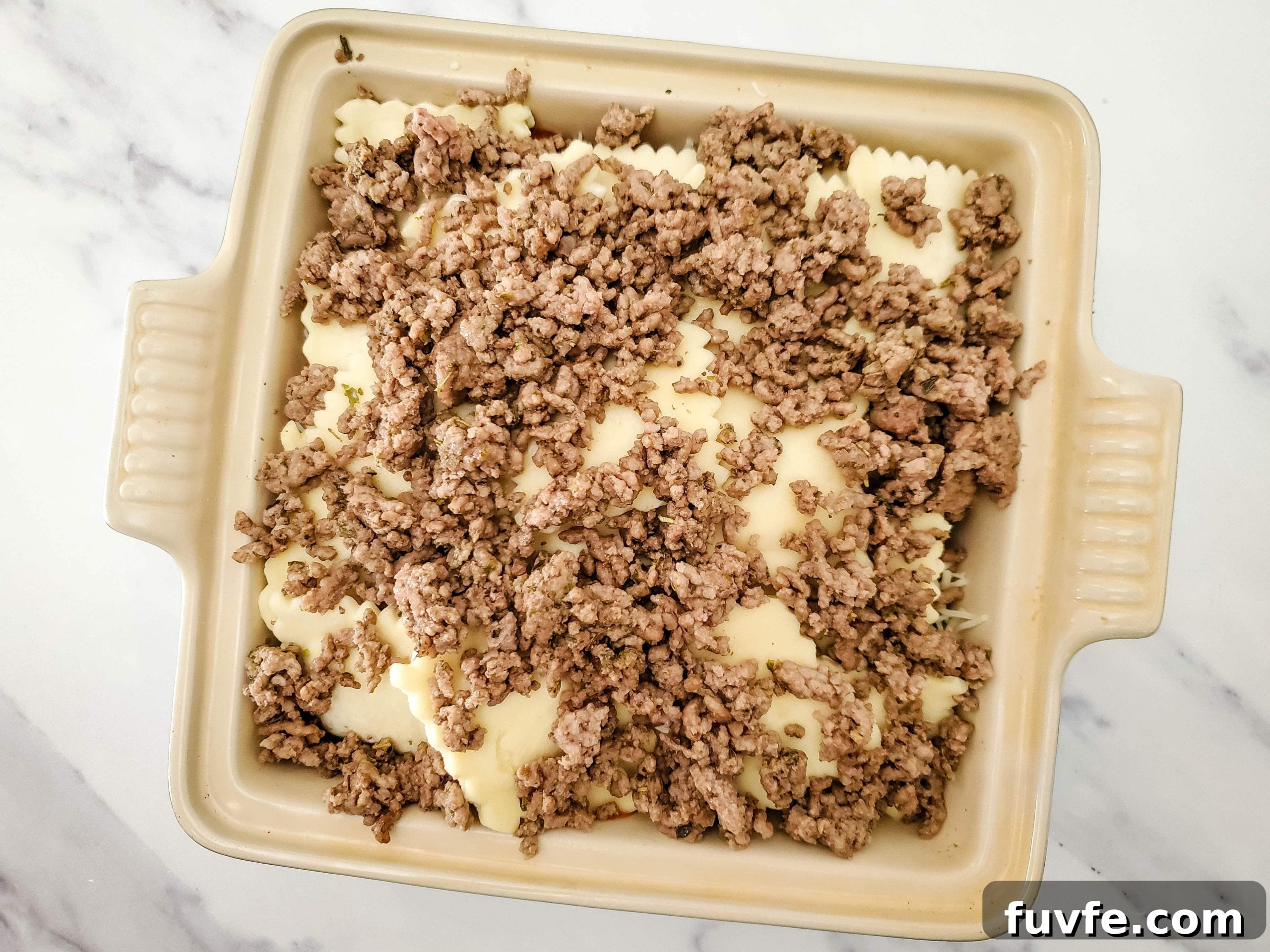 Quick Ravioli Lasagna Recipe for Fast Weeknight Dinners 8 Neutral colored baking dish with frozen ravioli lasagna layers