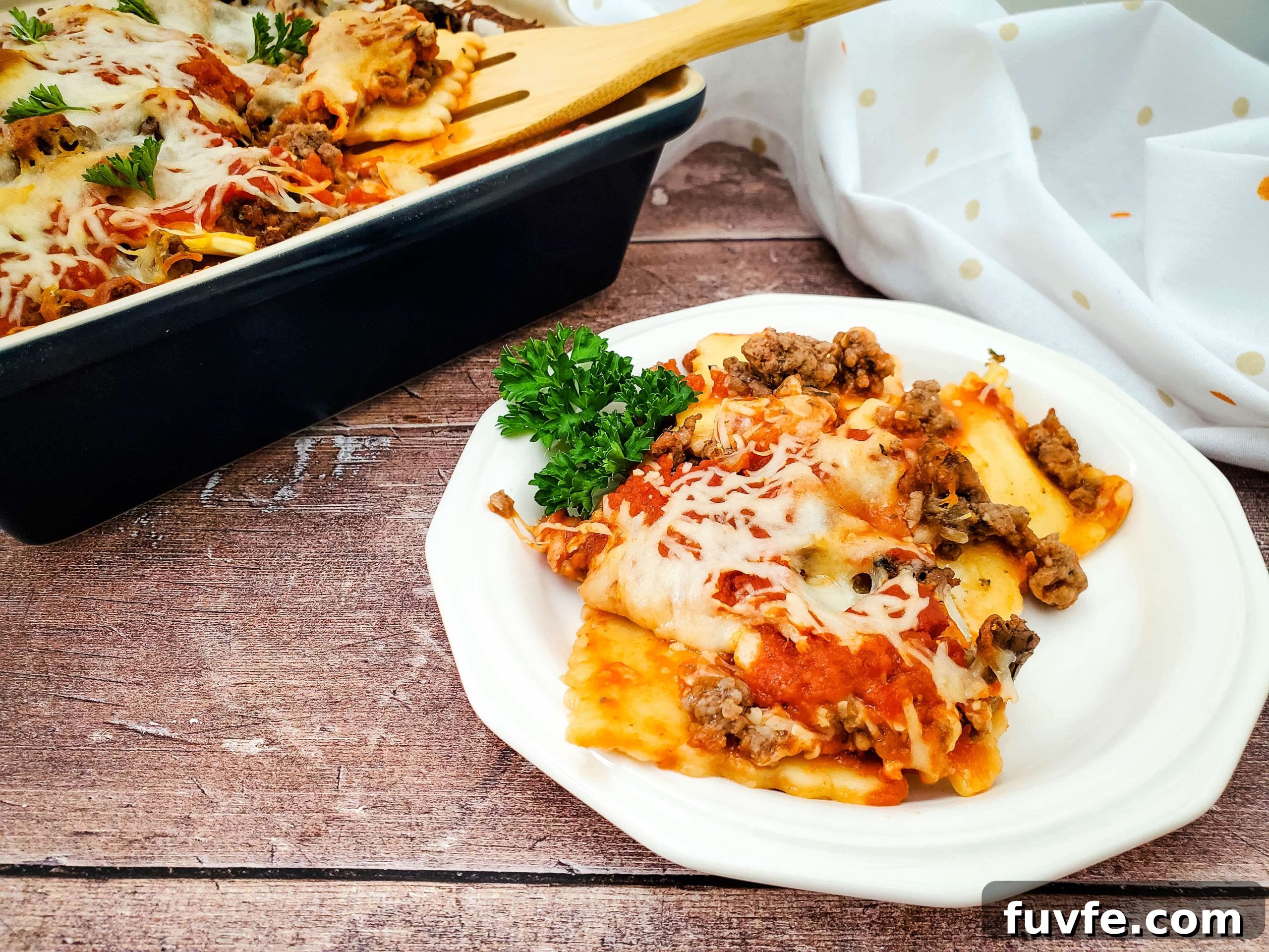 Quick Ravioli Lasagna Recipe for Fast Weeknight Dinners 10 Image of finished frozen ravioli lasagna plated on white dish.