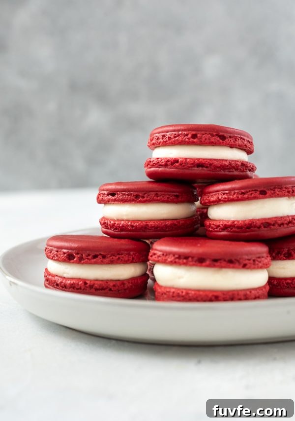 plate of red velvet macarons stacked up