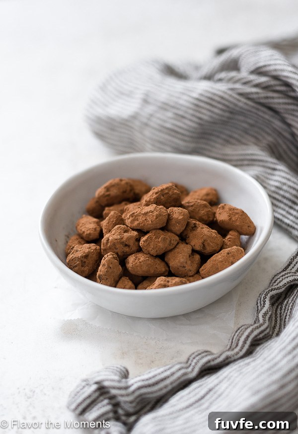 Almond dragees in a white bowl with a linen