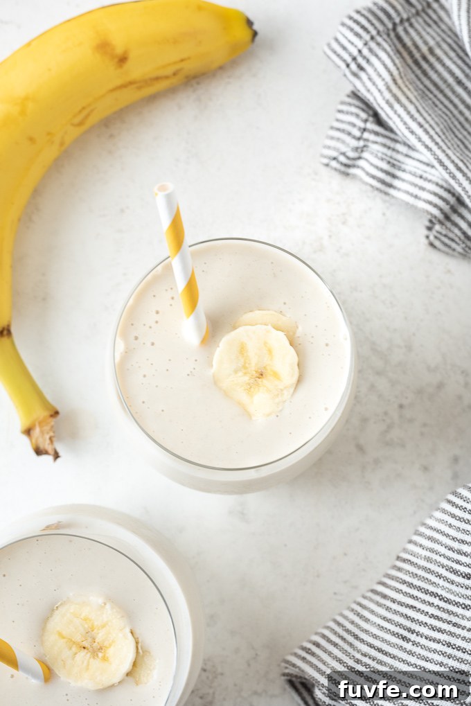 Creamy Banana Smoothie Recipe with Yogurt and Honey 3 Banana smoothie recipe with straw and slice of banana on top