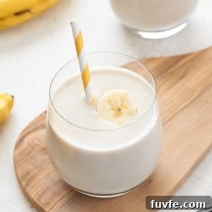 Creamy Banana Smoothie Recipe with Yogurt and Honey 7 Banana smoothie in a glass with straw and banana slice