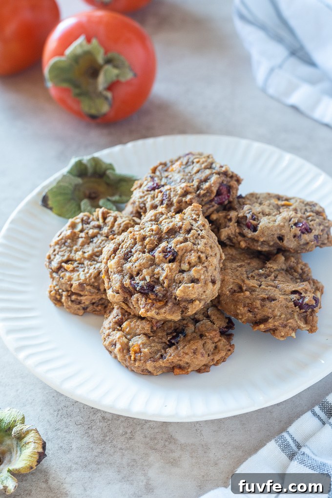 Persimmon oatmeal cookies piled on a white plate
