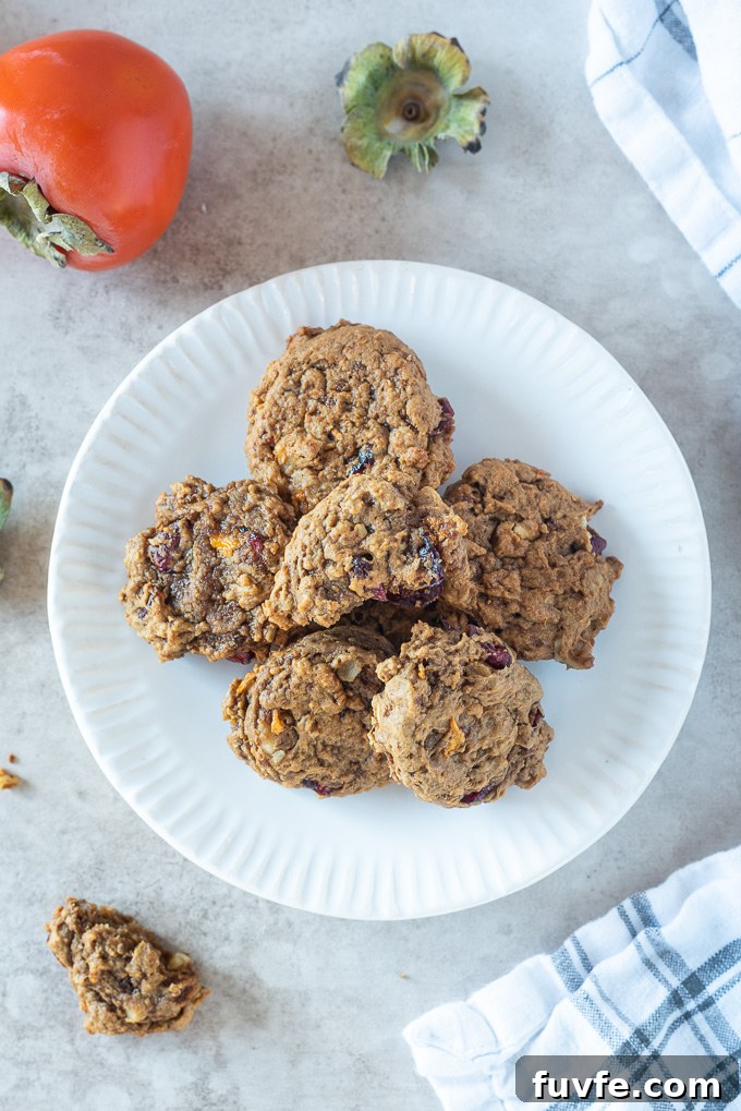Persimmon cookies on a plate with top cookie broken in half