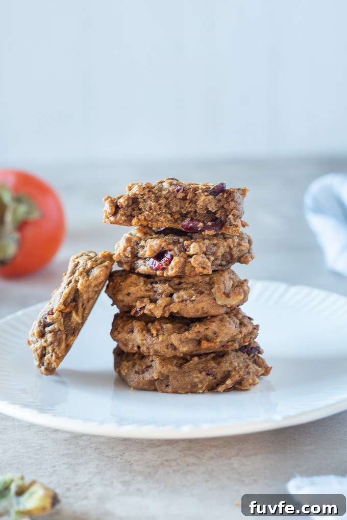 Stack of persimmon cookies on a plate with a cookie leaning on left side