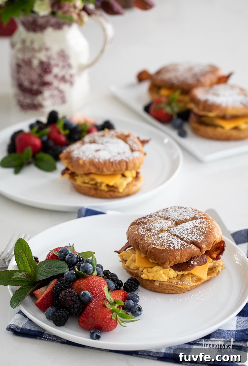 french toast breakfast sandwiches on plates served for breakfast.