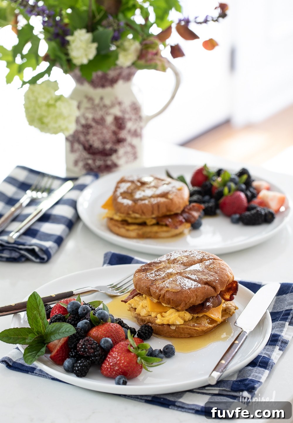 french toast breakfast sandwiches on plates on gingham napkins.