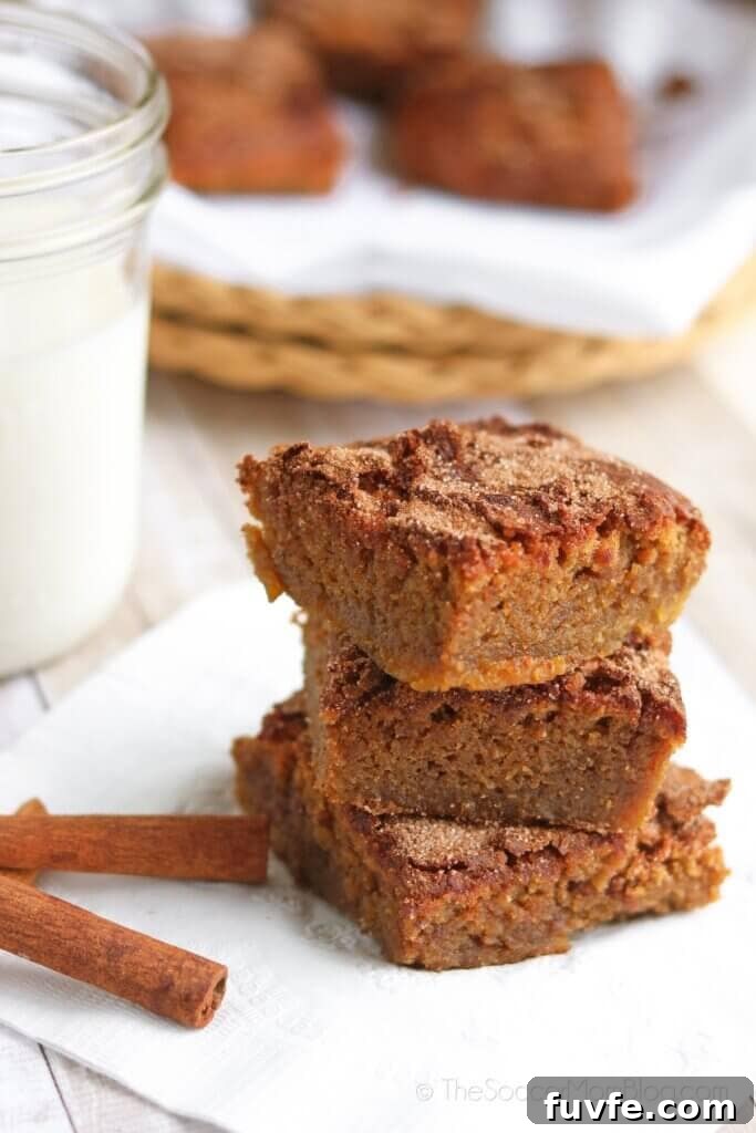 stack of chickpea blondies, cinnamon sticks, glass of milk