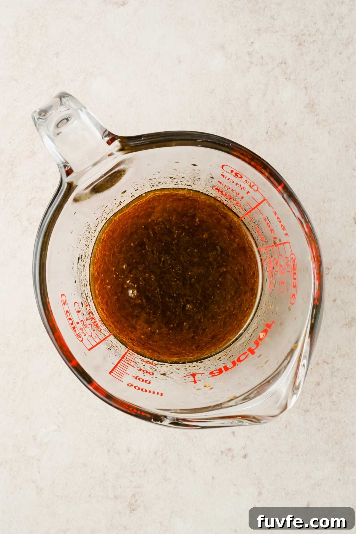 upgraded ramen sauce in glass beaker.
